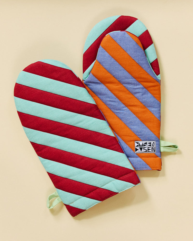Pumpnickel oven mitt in red, light green, orange, and grey on a beige background