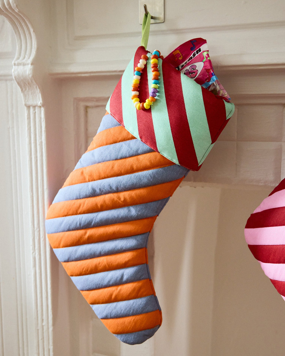 pumpernickel stocking in orange, grey, light green and red