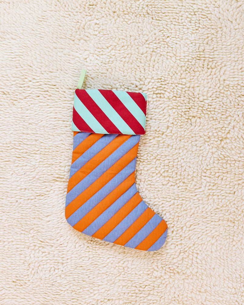 striped stocking in pumpernickel on beige carpet