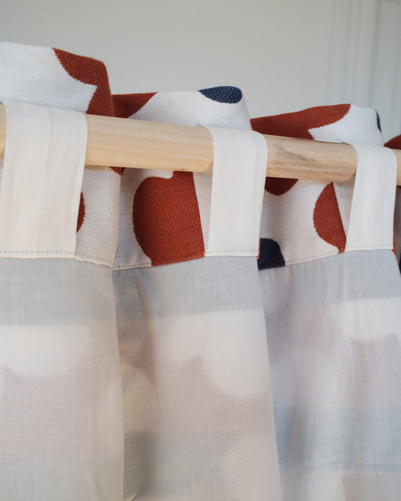 Curtain with white backing and back tab hanging