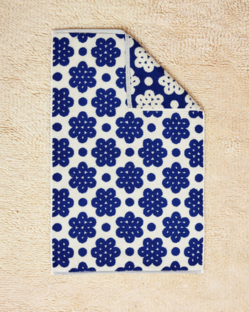 100% cotton towel with Raspberry Towel flat on cream rug 