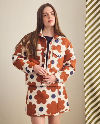 ["Woman wearing a patterned outfit with a beige background", " Just a Joyful Jacquard Jacket <br> <br> Erin is 5'8\" and wears a M"]