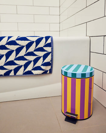 Ronnie trash bin in corner of bathroom 