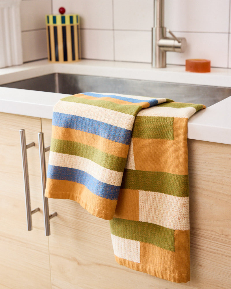 Salad dish towel hanging over sink in kitchen 