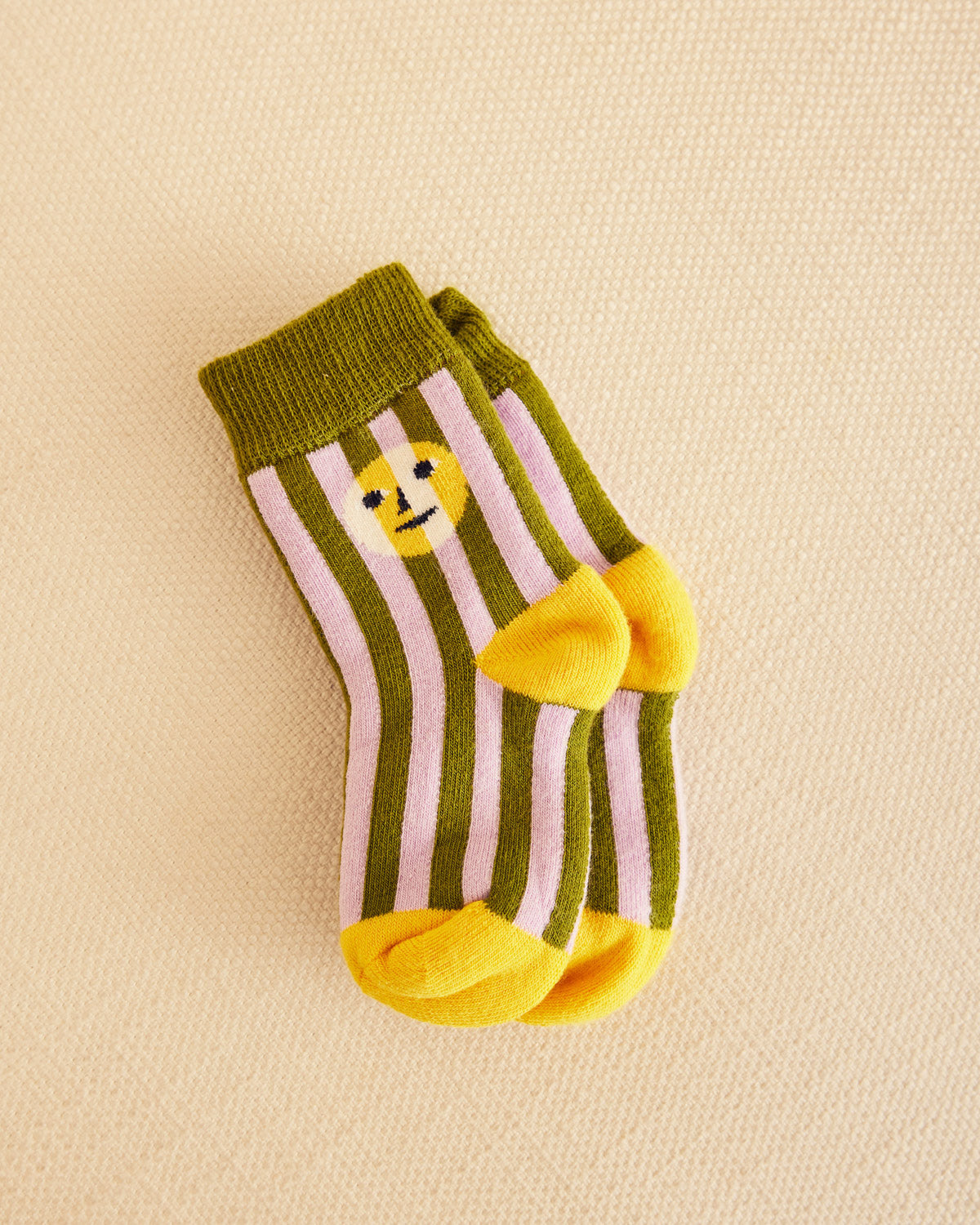 Sea stripe socks in purple and dark green on a beige background