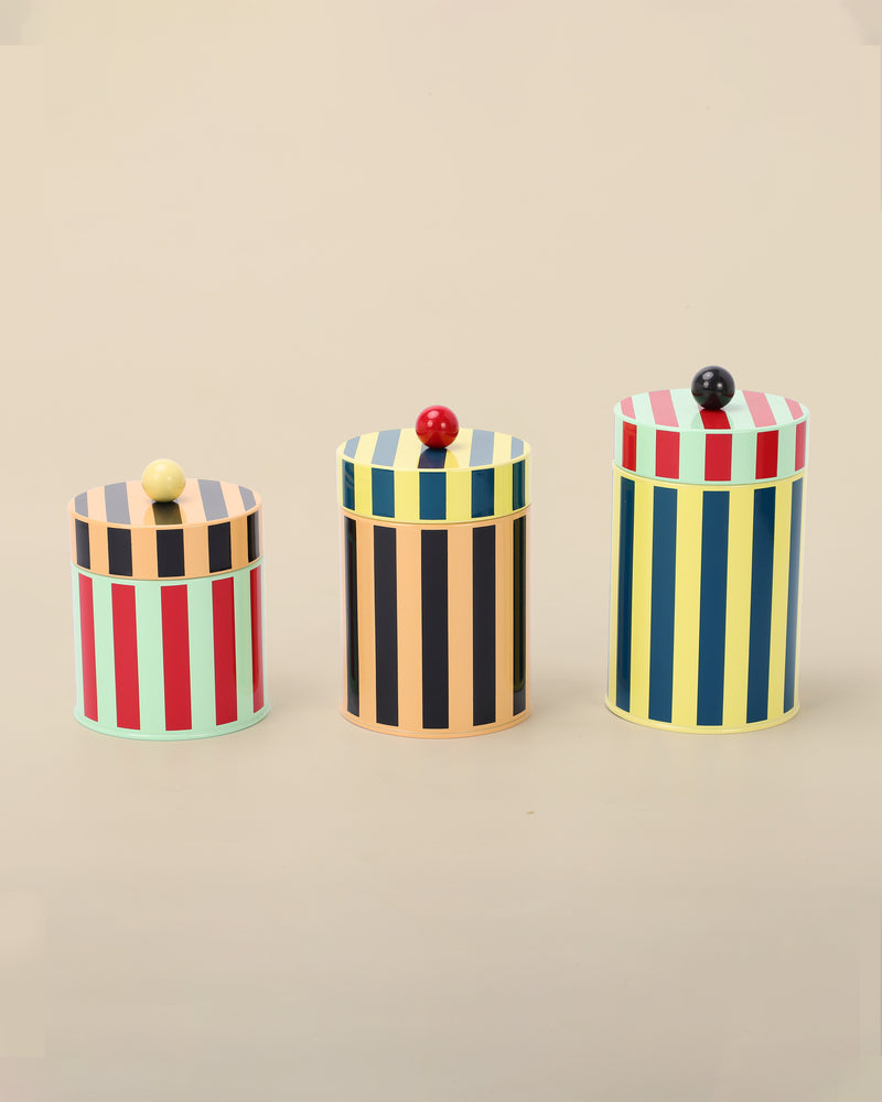 Three canisters on beige background