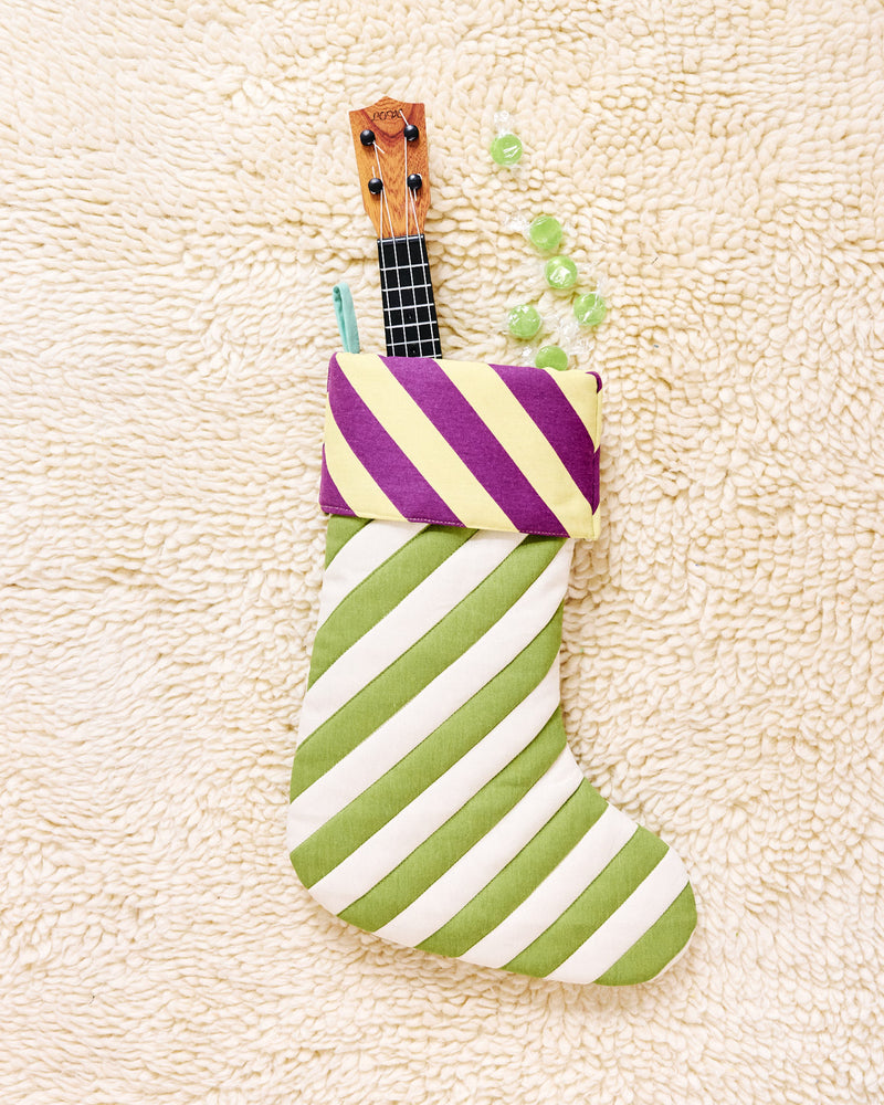 green and white stockings with yellow and purple trim on beige carpet