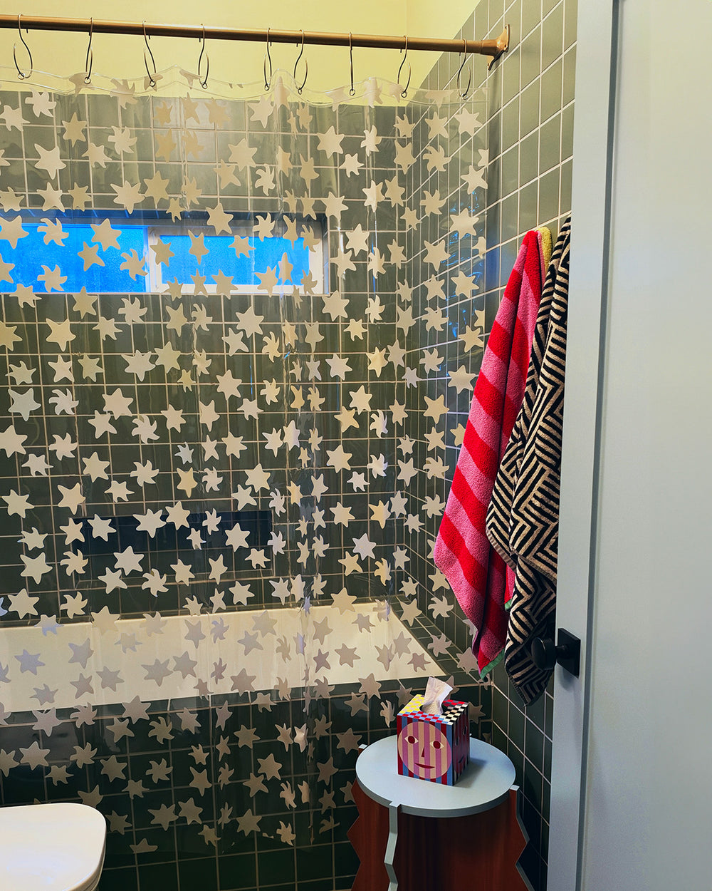 green tile bathroom with star shower curtain close up