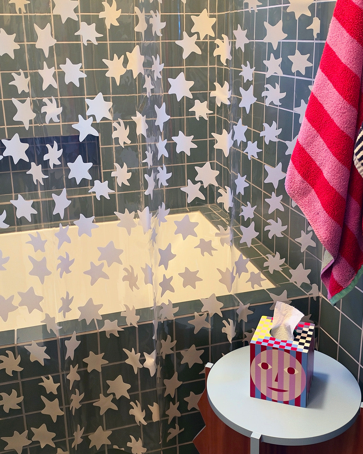 green tile bathroom with star shower curtain close up