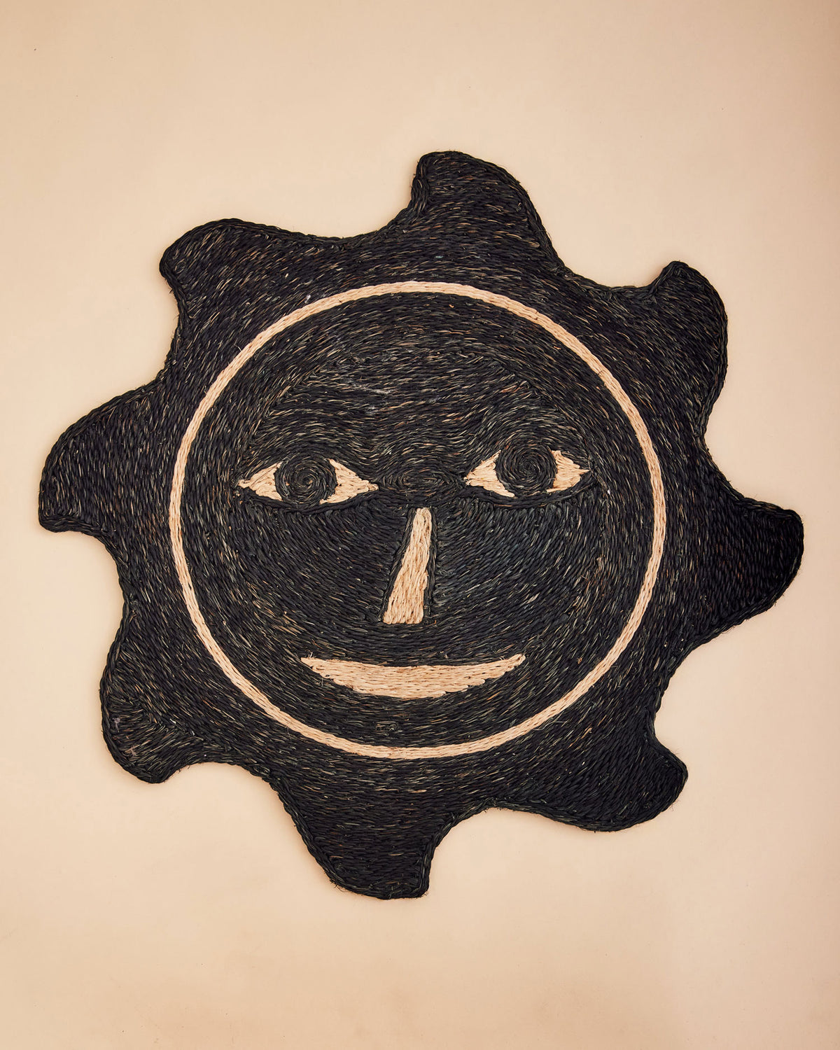 Dusen Dusen Everybody Sun Mat. Doormat made of 100% Handwoven Abaca fiber in the signature Everybody Face design. Made in Philippines. Dry, indoor use is recommended. Vacuum regularly, spot clean as needed.