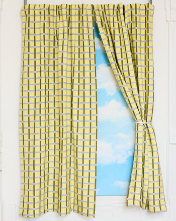 Yellow checkered curtains with a blue sky and white clouds background