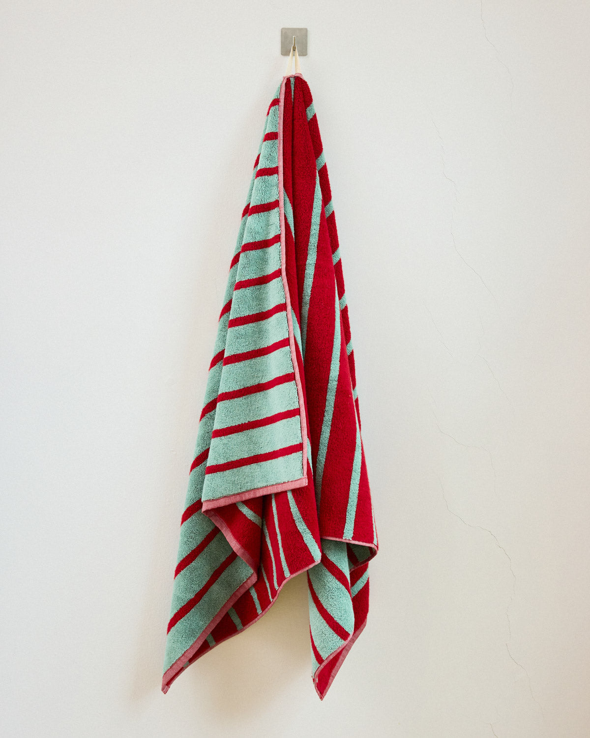 blue and red stripe towel on hook