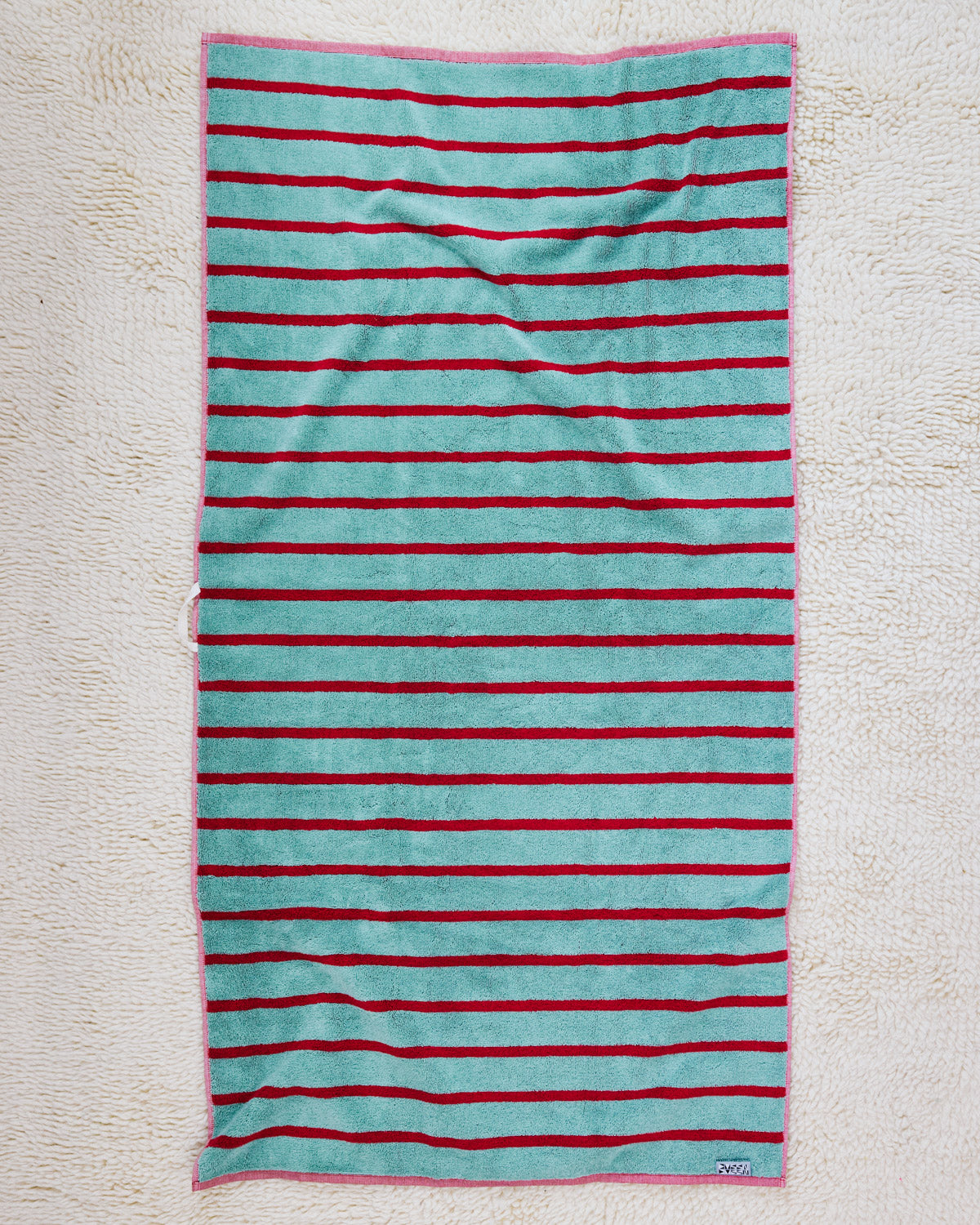 Blue and red stripe towel on rug