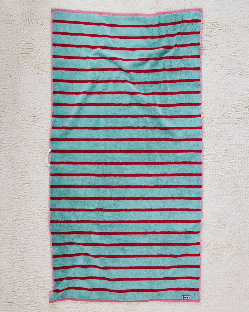 Blue and red stripe towel on rug