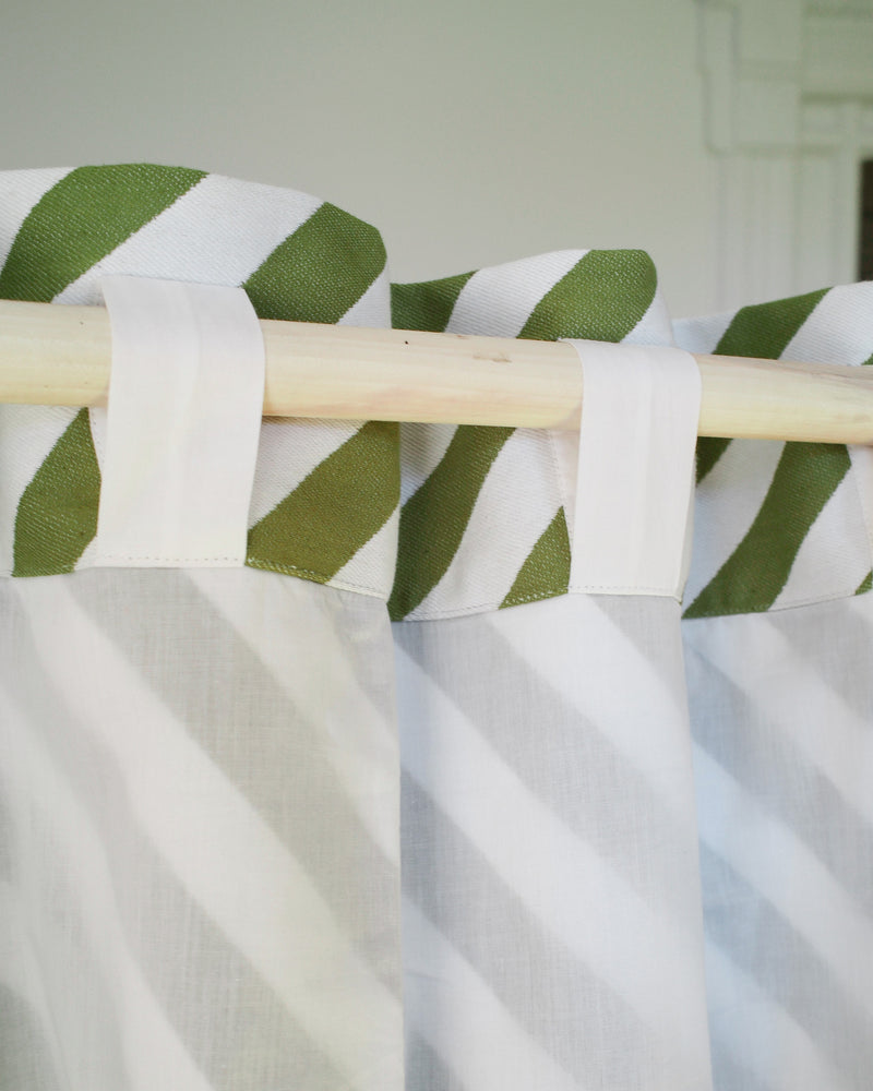 White curtain with green striped valance on a wooden rod against a white background