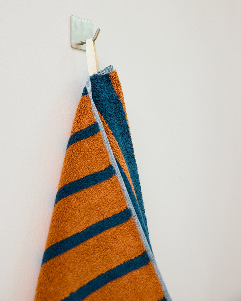 orange and blue towel on hook