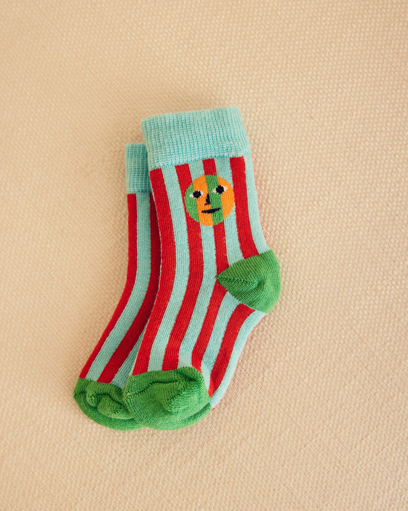 Red and light blue striped socks on a beige background