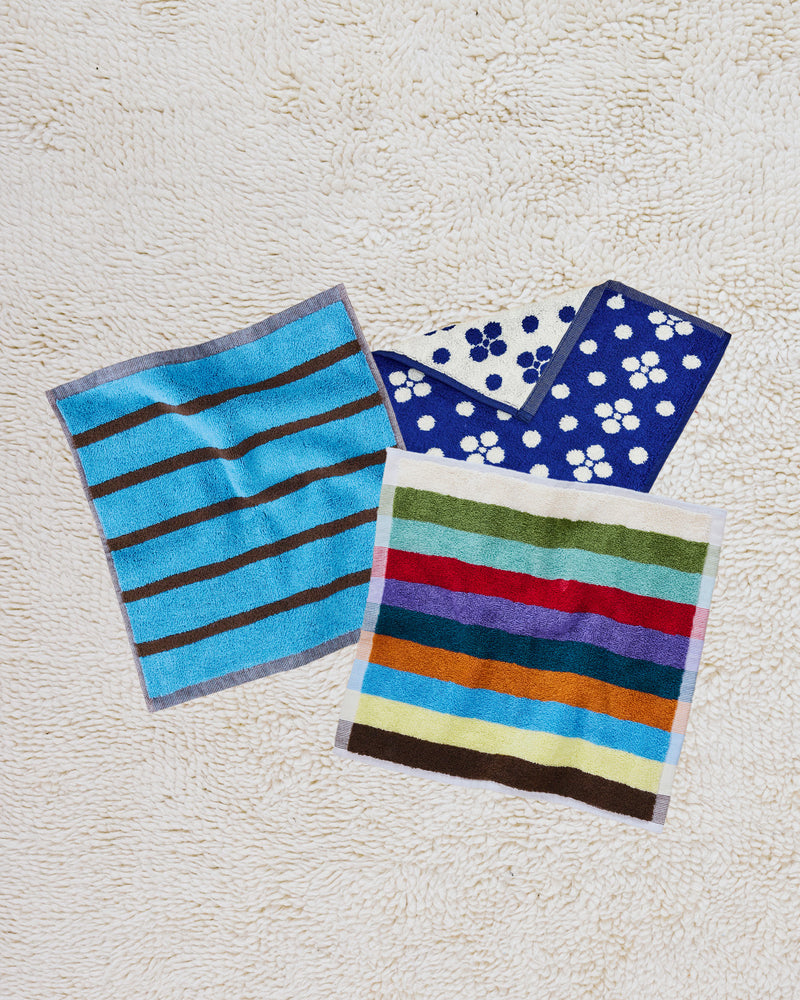 ["Three colorful towels with different patterns on a textured surface ", " It's a washcloth party, and everyone's invited <br> <br>Comes with:\n<br>\n1 Lisa Washcloth (from Navy Towel Collection)<br>\n1 Hummingbird Washcloth (from our Hummingbird Towel Collection)<br>\n1 Heron Washcloth (from our Bird Stripe Towel Collection)"]