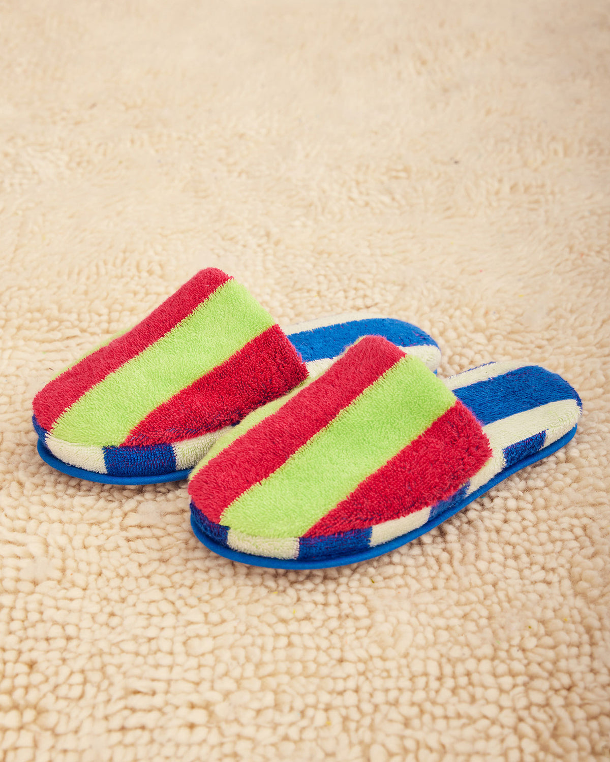 Dusen Dusen Stripe Slippers in Garden. Contrasting stripes and colorways on the outer shell and plush inner sole. 95% Cotton, 450gsm and 5% Polyamide/Nomex/Meryl. This item is Oeko-Tex Standard 100 certified (no harmful chemicals were used during production). Made in Portugal.