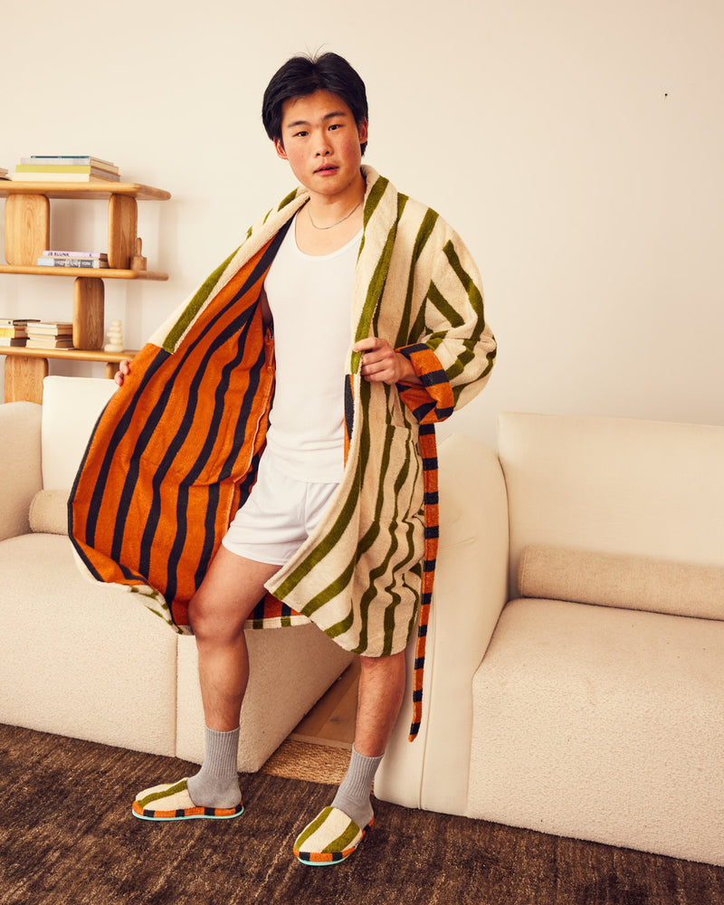 Jesse wearing orange interior robe open with matching slippers