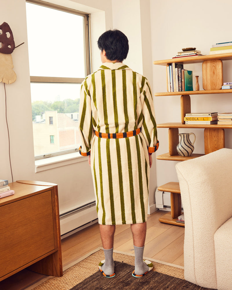 Jesse wearing Juniper slippers from behind in living room