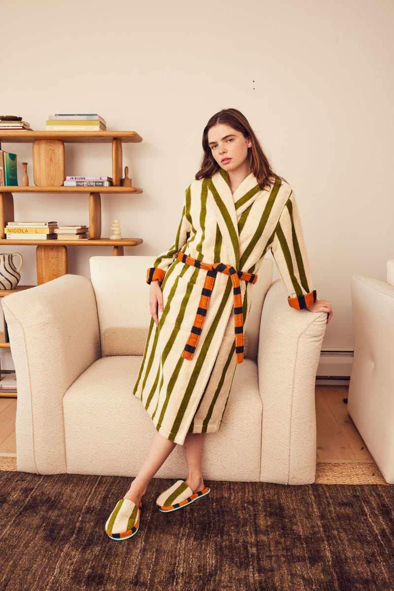 Erin in Juniper bathrobe leaning on couch