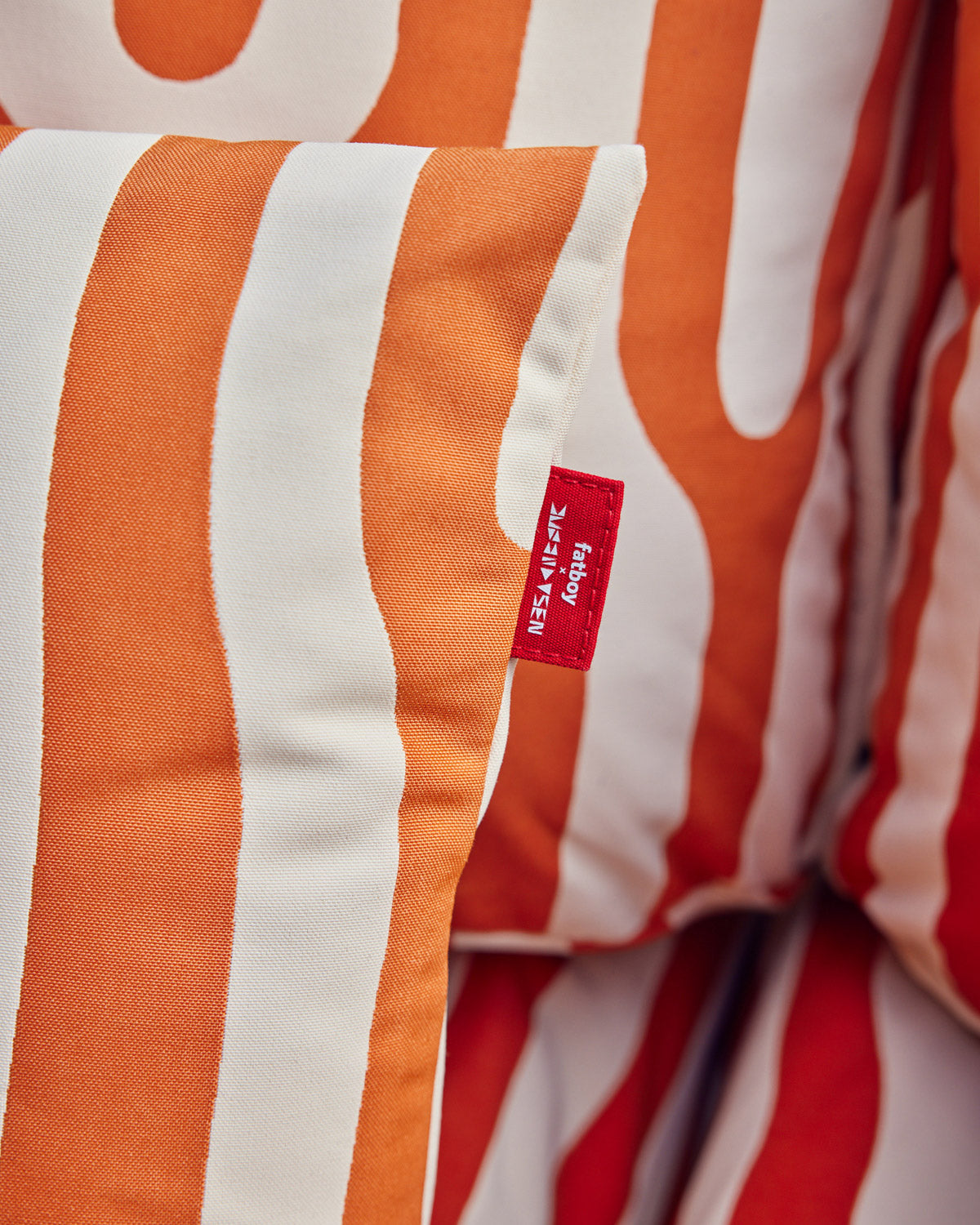 Fatboy x Dusen Dusen pillow close up of tag on oak pillow on oak piletti couch