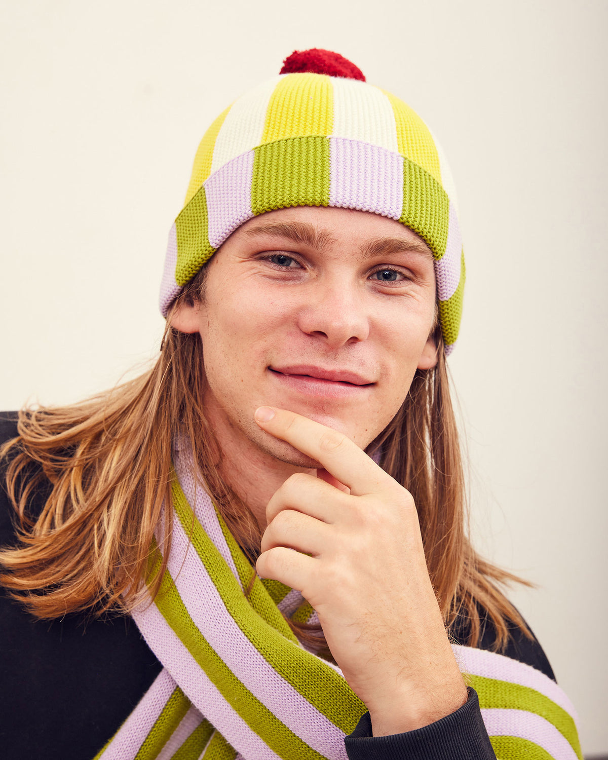 Squash Stripe Hat. Ribbed-knit pom beanie with contrasting yellow, white, lilac, and green stripes. 100% Cotton. Made in China.