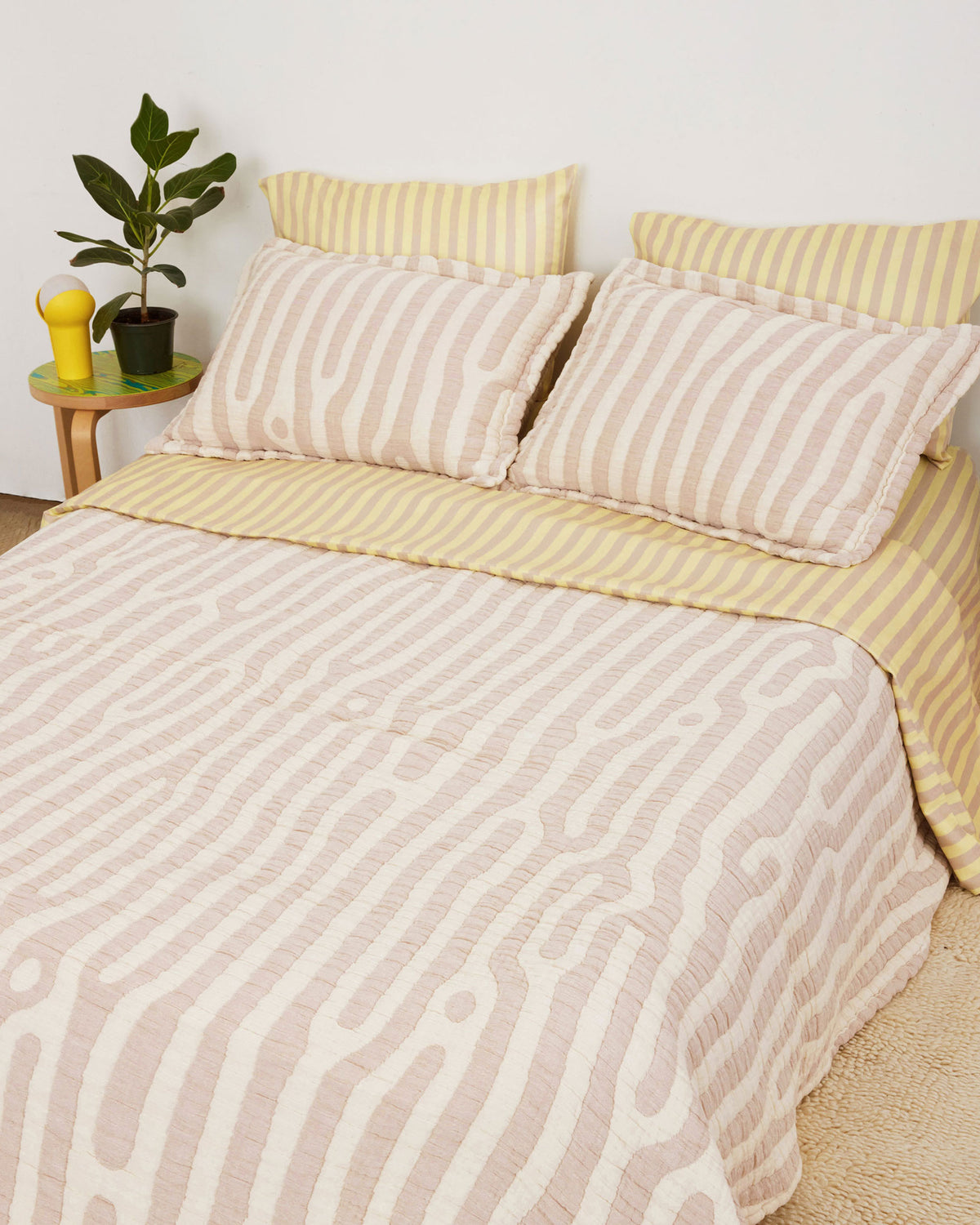 Birch Coverlet Set in tan and cream Birch print. Stone-washed, woven matelassé coverlet with an inner layer of insulation for a quilted effect. Extra soft and gauzy hand feel. 100% cotton shell, polyester fill. Made in Portugal.