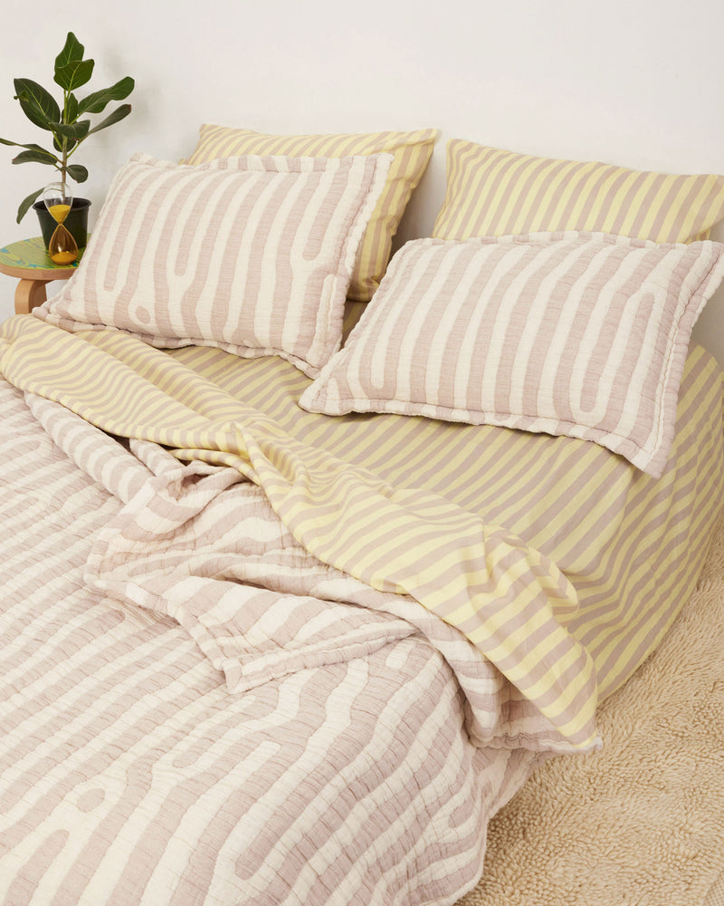 Set of Shams in tan and cream Birch print. Stone-washed, woven matelassé coverlet with an inner layer of insulation for a quilted effect. Extra soft and gauzy hand feel. 100% cotton shell, polyester fill. Made in Portugal.
