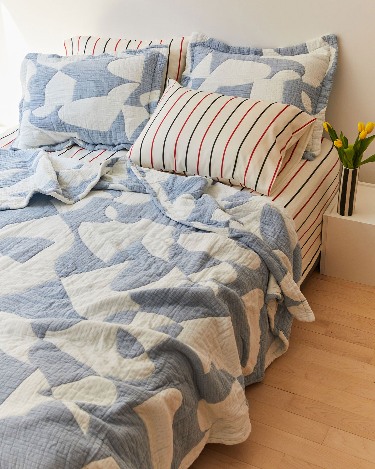Dusen Dusen Hepta Coverlet Set. Coverlet Set in blue and white Hepta print. Woven matelassé coverlet with inner layer of insulation for a quilted effect. Stone washed, with an extra soft and gauzy hand feel. 100% cotton shell, polyester fill. Machine wash cold and tumble dry low. Made in Portugal.