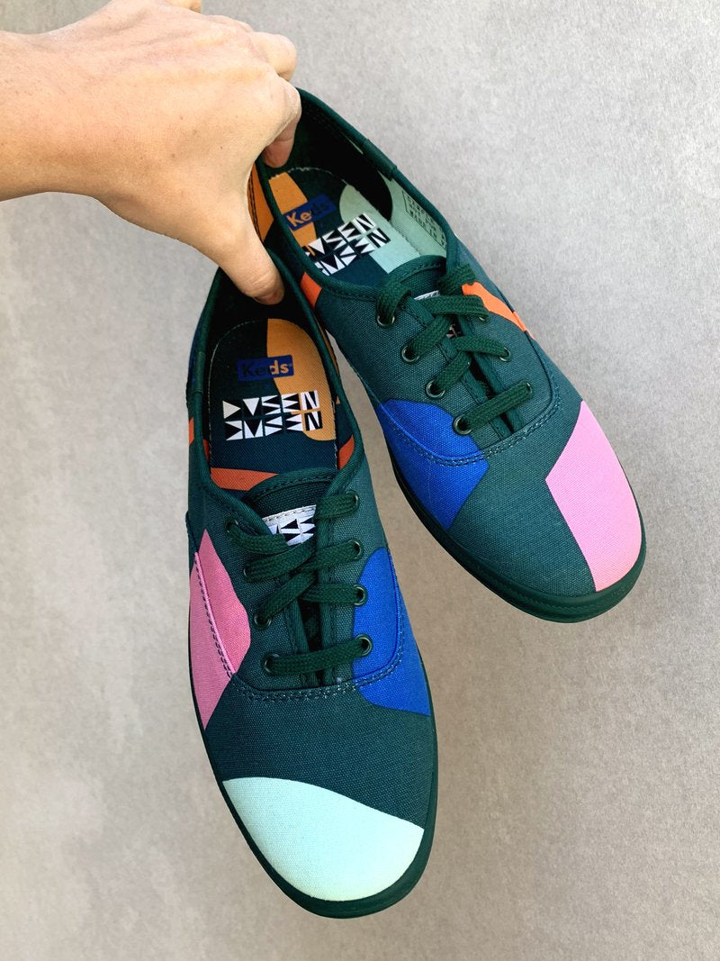green shoes with colorful blocks being held