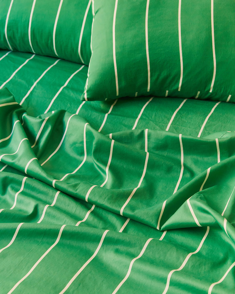 Dusen Dusen Lawn Stripe Sheets. Sheeting in green and white stripes. 100% cotton sateen, 300 thread count. Machine wash cold and tumble dry. Made in Portugal. Our cotton sateen is smooth and cool to the touch and features a slightly lustrous finish.