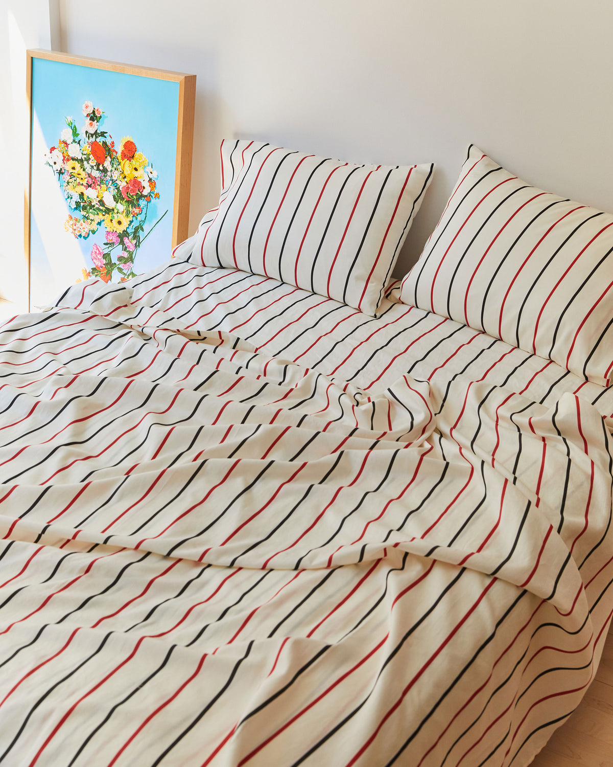 Dusen Dusen Lowlands Stripe Sheets. Sheeting in white, black and red stripes. 100% cotton sateen, 300 thread count. Machine wash cold and tumble dry. Made in Portugal. Our cotton sateen is smooth and cool to the touch and features a slightly lustrous finish.