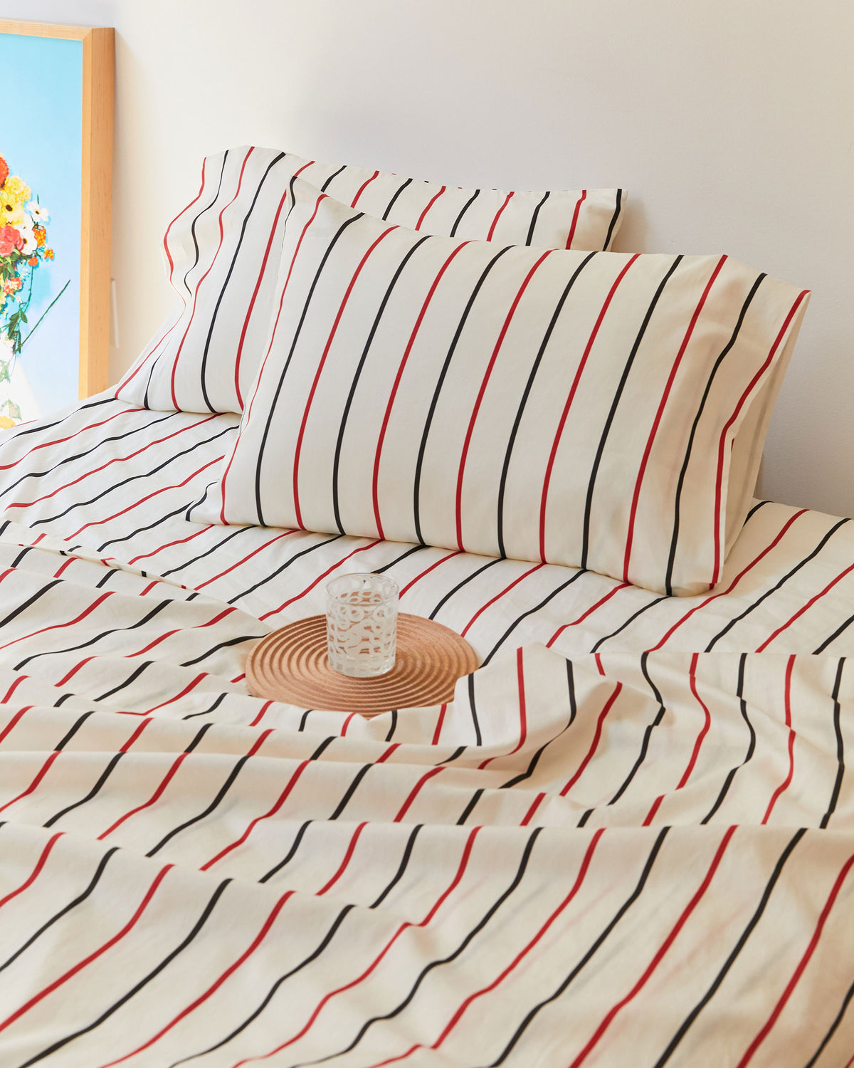 Dusen Dusen Lowlands Stripe Sheets. Sheeting in white, black and red stripes. 100% cotton sateen, 300 thread count. Machine wash cold and tumble dry. Made in Portugal. Our cotton sateen is smooth and cool to the touch and features a slightly lustrous finish.