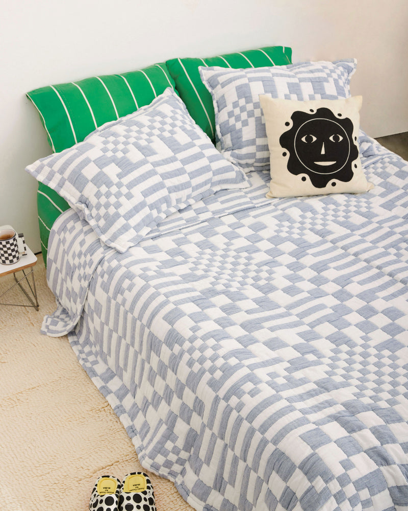 Dusen Dusen Navy Check Coverlet. Coverlet Set in navy and white Check print. Woven matelassé coverlet with an inner layer of insulation for a quilted effect. Stone-washed, with an extra soft and gauzy hand feel. 100% cotton shell, polyester fill. Machine wash cold and tumble dry low. Made in Portugal.