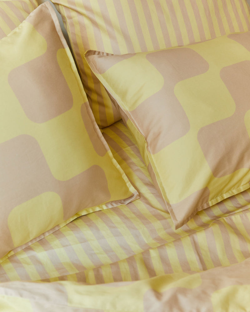 Dusen Dusen Net Duvet Set. Duvet cover in tan and butter yellow Net print. 100% cotton sateen, 300 thread count. Machine wash cold and tumble dry. Made in Portugal. Our cotton sateen is smooth and cool to the touch and features a slightly lustrous finish.