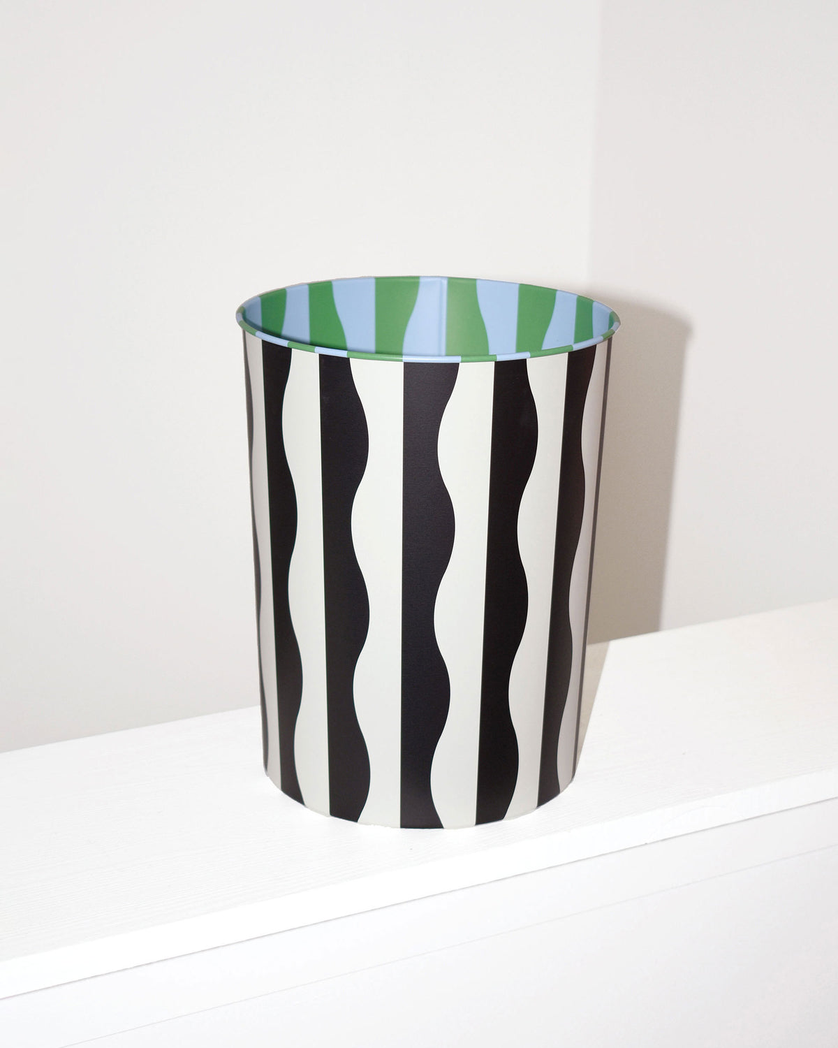 River Pattern Bin. Patterned wastepaper bin made in collaboration with Areaware. Great for use in office or bathroom. 100% tin. 8.25 in x 10.5 in. Made in China. Not eligible for international shipping.