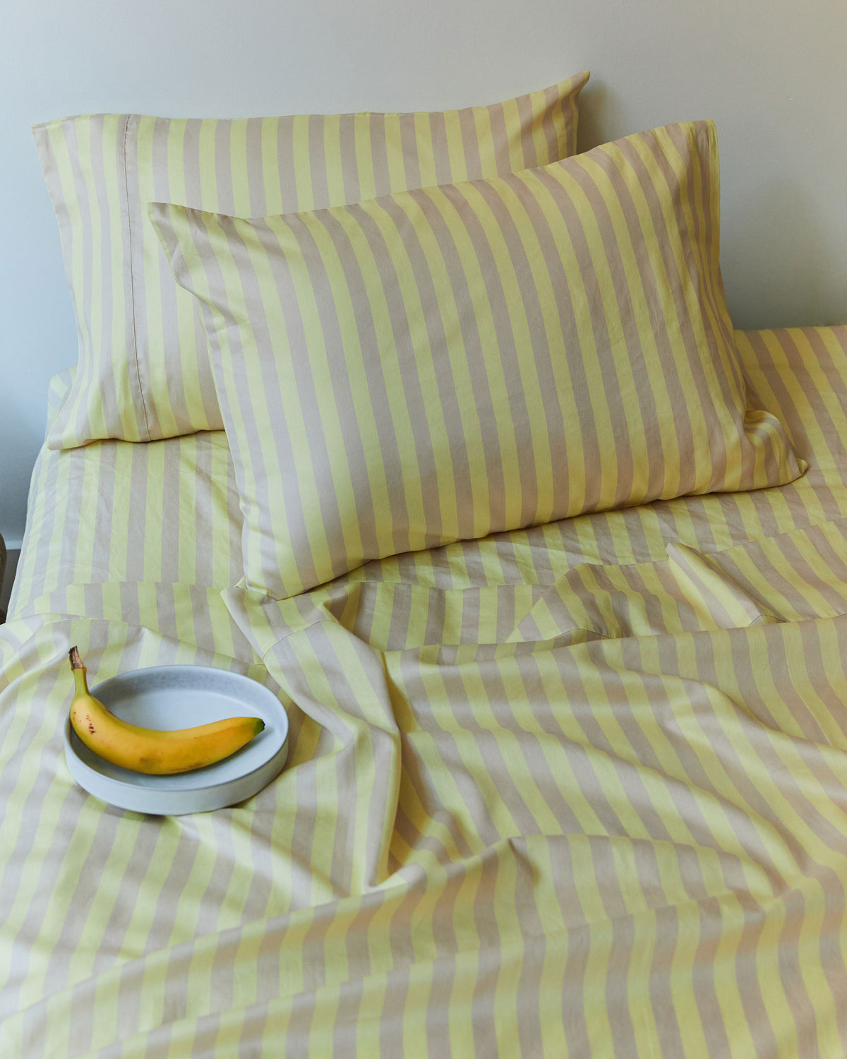 Dusen Dusen Sand Stripe Sheets. Flat Sheet and Sheet Sets in tan and yellow stripes. 100% cotton sateen, 300 thread count. Machine wash cold and tumble dry. Made in Portugal. Our cotton sateen is smooth and cool to the touch and features a slightly lustrous finish.