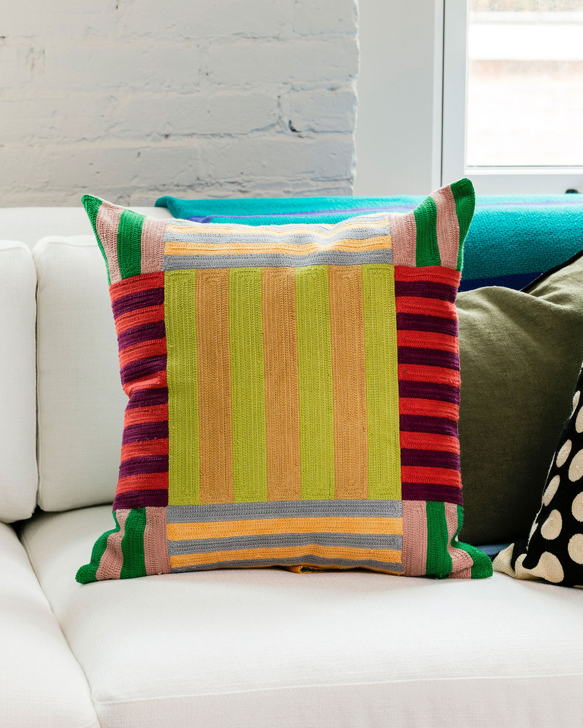 Dusen Dusen Stripe Pillow. Embroidered pillow with multi-color Stripe pattern. 100% cotton, back zip, non-embroidered natural canvas back. Available as 18" x 18". Spot clean only. Made in India.  Pillow insert is a polyfill down alternative and mimics the fluffiness of natural down. Insert is made in USA.