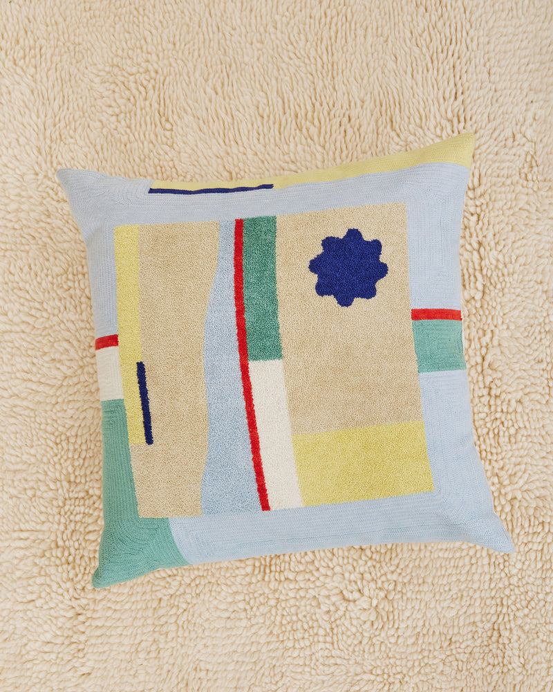 Dusen Dusen Sunrise Pillow Cover. Sunrise pillow in multi-color abstract pattern. 100% cotton tufted pillow. Natural canvas back with zip closure. Available as 24" x 24". Spot clean only. Made in India.