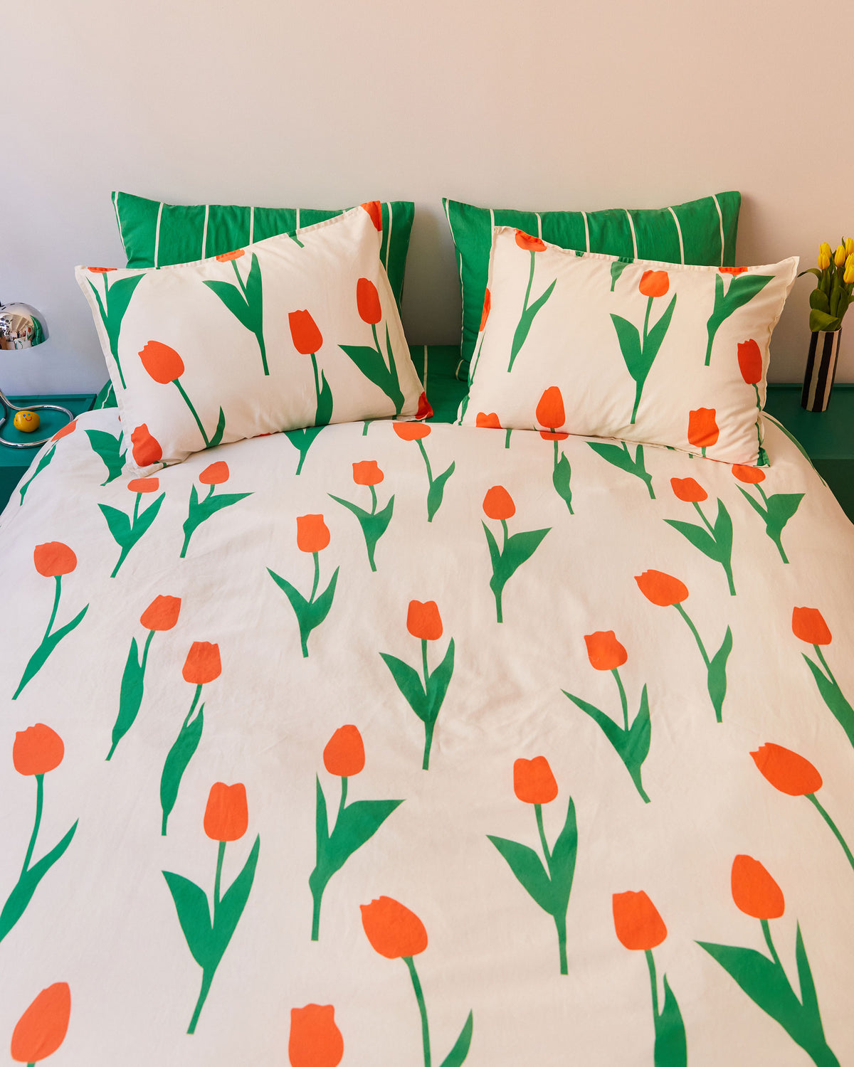 Dusen Dusen Tulip Duvet Set. Duvet cover in cream with red and green Tulip print. 100% cotton sateen, 300 thread count. Machine wash cold and tumble dry. Made in Portugal. Our cotton sateen is smooth and cool to the touch and features a slightly lustrous finish.