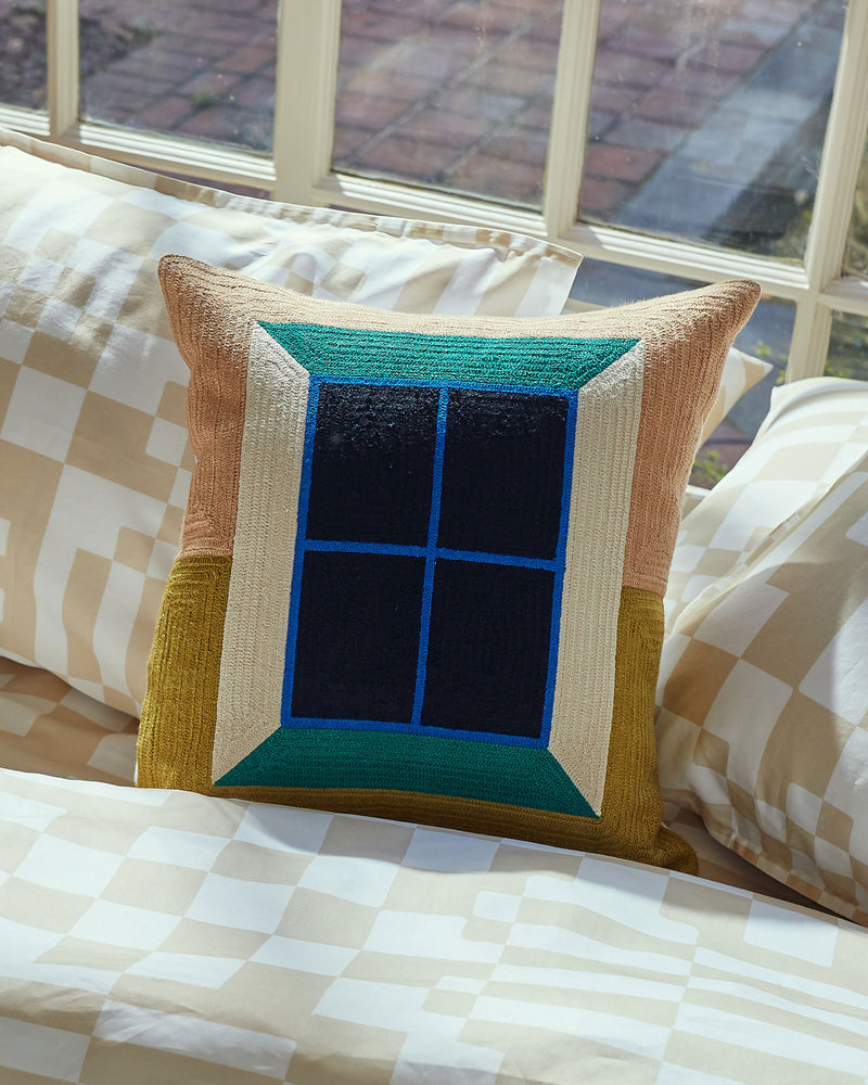 Dusen Dusen Window Pillow. Embroidered pillow in multi-colored Window print. 100% cotton, back zip, non-embroidered natural canvas back. Available as 18" x 18". Spot clean only. Made in India.  Pillow insert is a polyfill down alternative and mimics the fluffiness of natural down. Insert is made in USA.