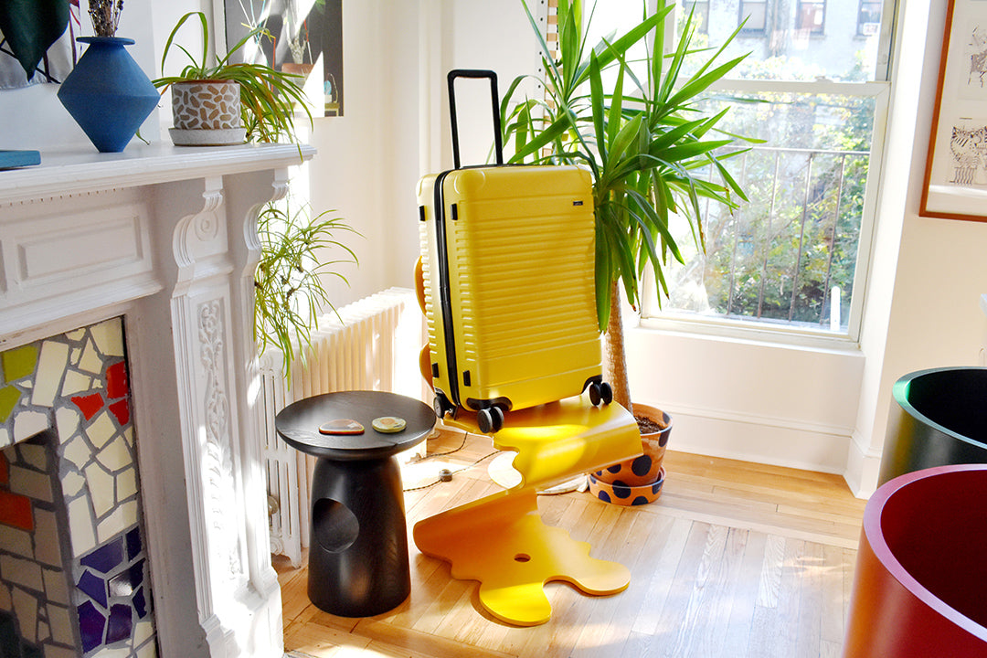 yellow suitcase on yellow chair in home