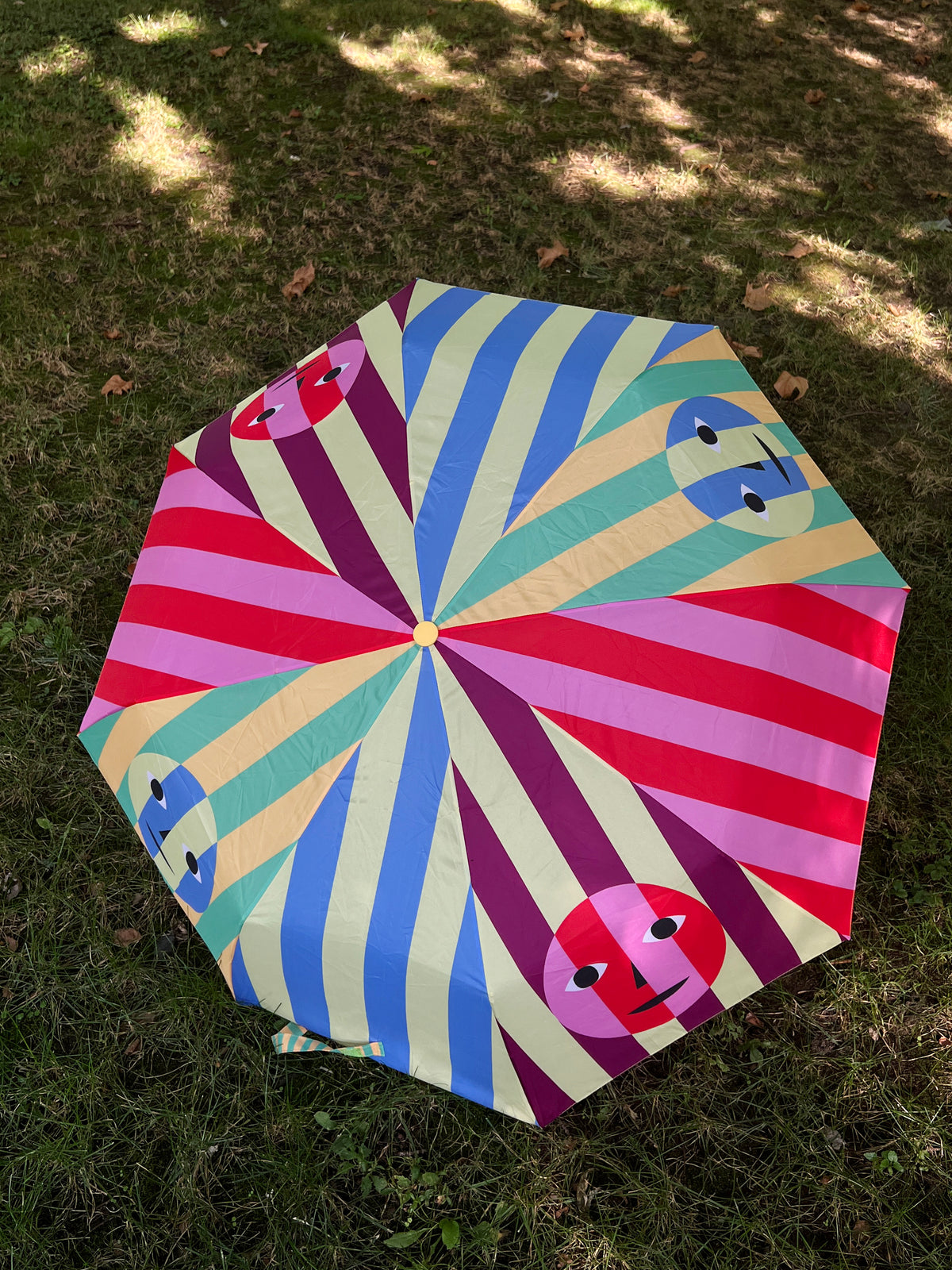 Dusen Dusen Everybody Face Umbrella. Everybody Umbrella made in collaboration with Areaware. Multi-colored stripe pattern with Face print on each side.