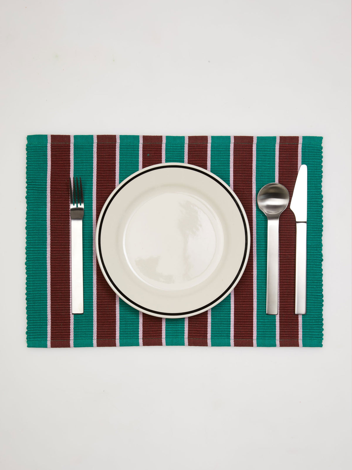 Dusen Dusen Porcini Striped Placemat. Cotton placemats in tri-color stripes with a ribbed texture. 100% cotton, 12" x 18". Machine wash cold and lay flat to dry. Spot clean as needed. Made in India.