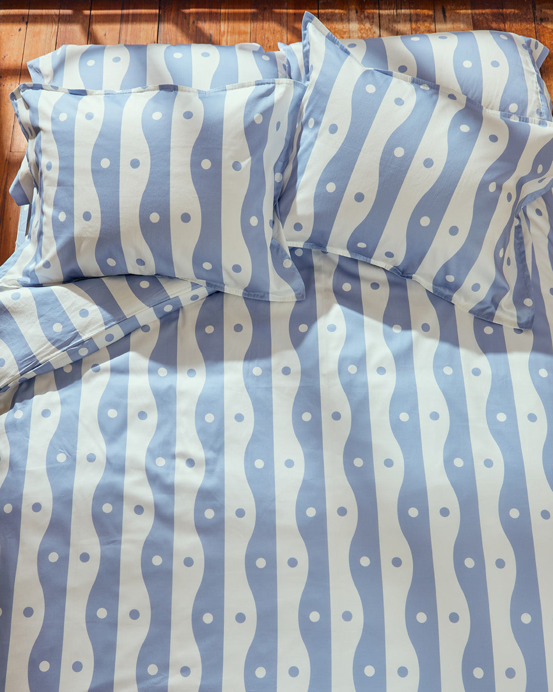 Dusen Dusen River Bedding. Duvet and Sheet Sets in blue and white River print. Include an individual Flat Sheet to round out a Sheet Set. 100% cotton sateen, 300 thread count. Machine wash cold and tumble dry. Made in Portugal. Our cotton sateen is smooth and cool to the touch and features a slightly lustrous finish.