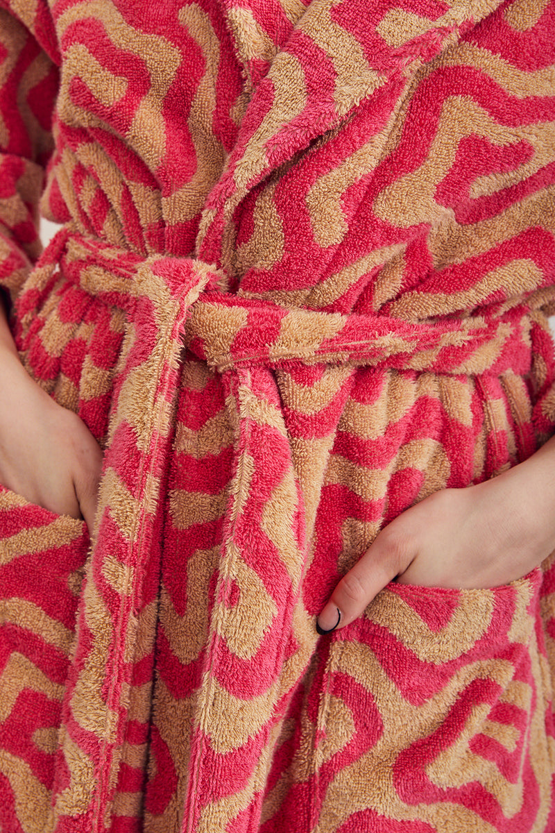 Bathrobe in Spiral pattern. Cotton terry bathrobe with shawl collar, patch pockets, and tie in hot pink and taupe Spiral pattern. 100% cotton terry, 450 gsm. Made in Turkey. This item is Oeko-Tex Standard 100 certified (no harmful chemicals were used during its production).
