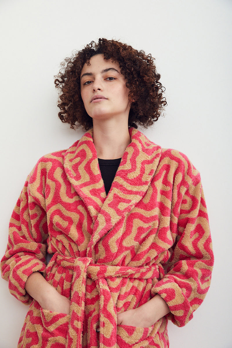 Bathrobe in Spiral pattern. Cotton terry bathrobe with shawl collar, patch pockets, and tie in hot pink and taupe Spiral pattern. 100% cotton terry, 450 gsm. Made in Turkey. This item is Oeko-Tex Standard 100 certified (no harmful chemicals were used during its production).